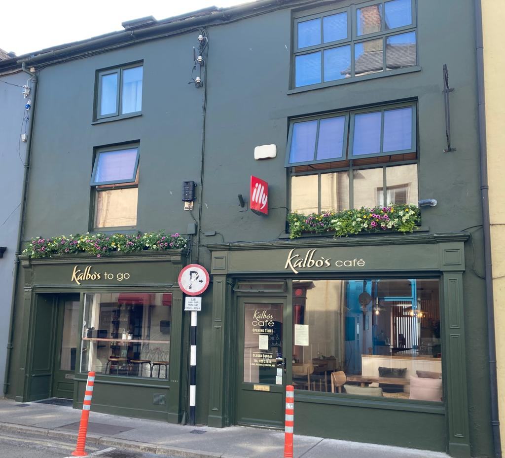 The Kalbo's to go and Kalbo's café shopfronts on North Street, painted dark green with flower boxes