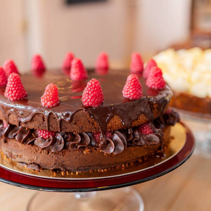 A chocolate ganache cake with raspberries