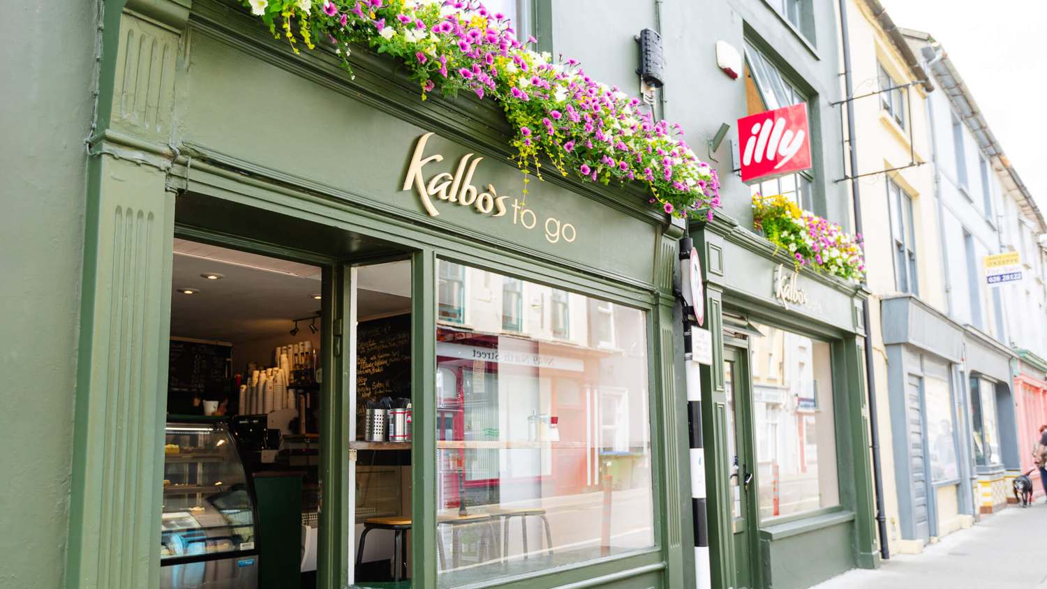 The dark green Kalbo's to go shopfront on North Street, Skibbereen, with hanging flower baskets